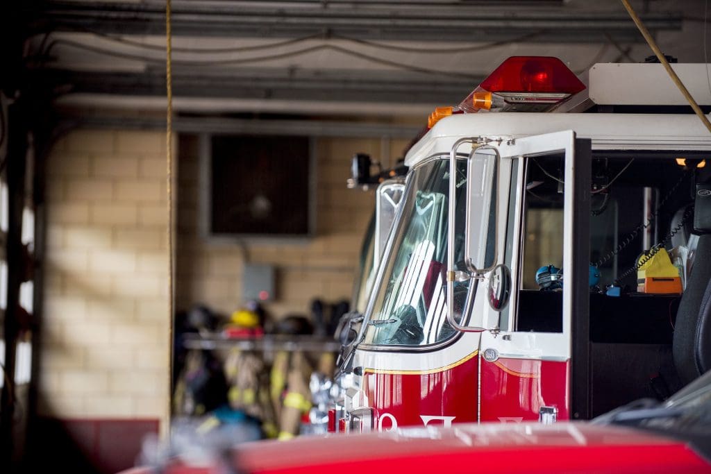 A closeup shot of a firetruck with an open door and a blurred background